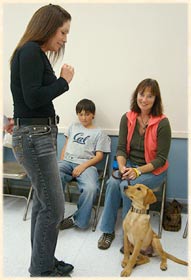 Laura teaching a dog to sit.